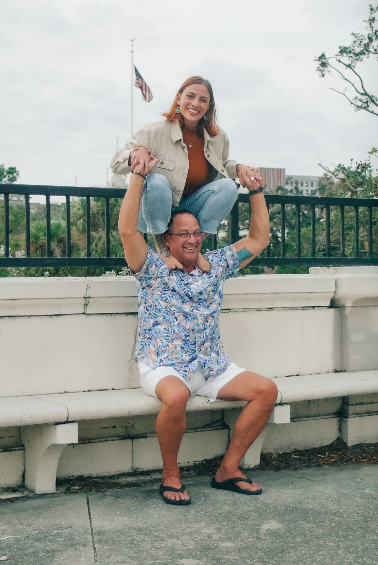 Father and daughter laughing during a playful Tampa Riverwalk portrait