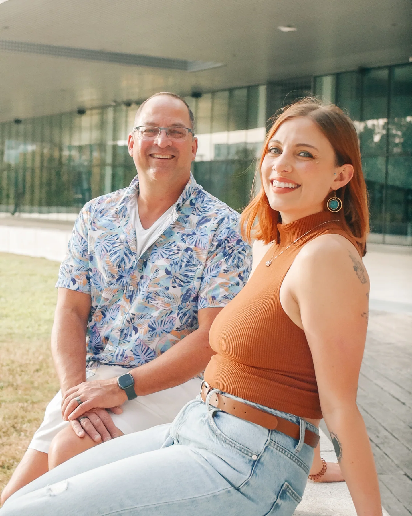 Father and daughter seated together during a Riverwalk portrait session