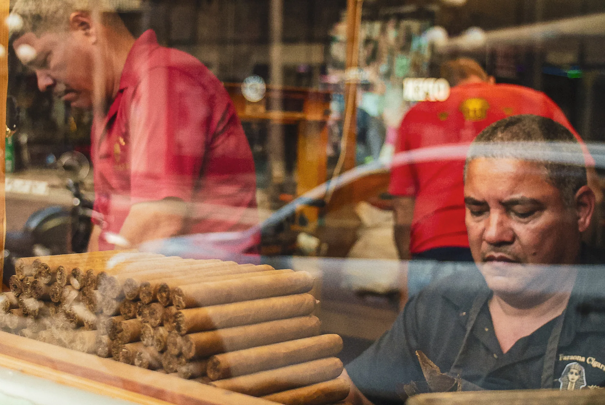 Cigar craftsman working behind a Ybor City shop window